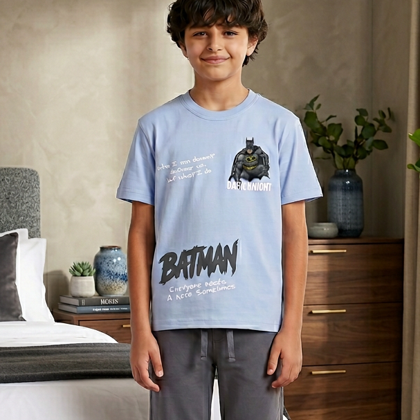 Child wearing a Batman t-shirt in a bedroom setting