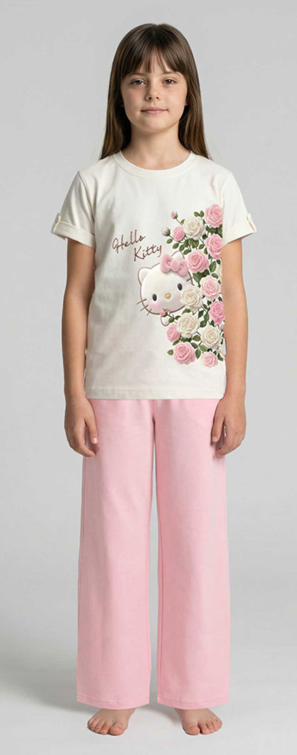 Young girl wearing a Hello Kitty pajama set with a floral design on a plain background
